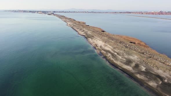 Bird's Eye View of Beach with Sand Grass and Stones Washed By Bay of Black Sea and Lake Under Sky in alt