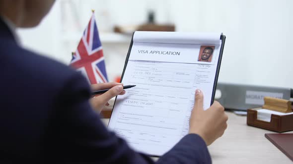 Consul Approving Visa Application, British Flag on Table, Official Permission alt