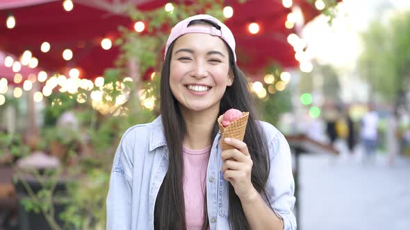 Cute asian woman holding ice cream.