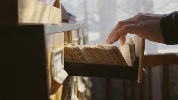 Man Opens Database Drawer, Young Librarian Opens Library Card Index, Archive, Database, Library alt