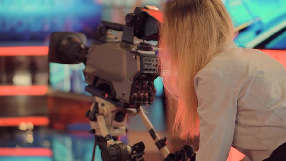 Woman Tv Camera Operator.Girl Working On Tv Studio Broadcasting Tv Channel.Making TV Show Or Film. alt