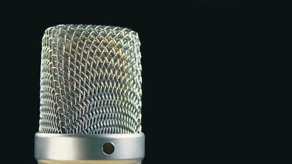 Studio Condenser Microphone Rotates on a Black Background alt