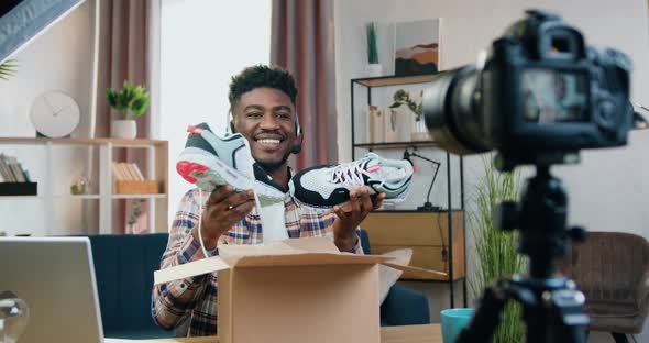 Black-Skinned Guy in Wireless Headset Recording Video for His Internet Audience alt