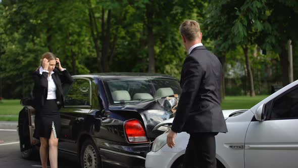 Guilty Male Driver Giving Female Money Compensation After Rear-End Collision