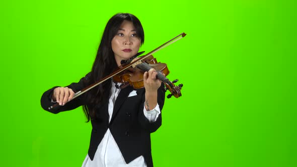 Musician Standing and Playing the Violin. Green Screen alt