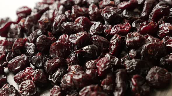 Red organic  cranberries on table 4K 2160p 30fps UltraHD panning footage - Shallow DOF dried berries alt