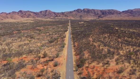 Desert road aerial in Australia outback near West MacDonnell National Park, Alice Springs, Northern alt