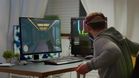 Cyber Sport Gamer Wearing Headphones Playing First Person Shooter Videogame alt