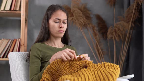 Latin Young Woman Knitting Warm Sweater Knit Accessories at Home Leisure and Hobby alt