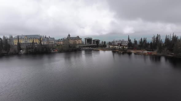 Aerial View of Strbske Pleso, Slovakia. Mountain Lake in Clouds and Snowy Tatras Mountains alt