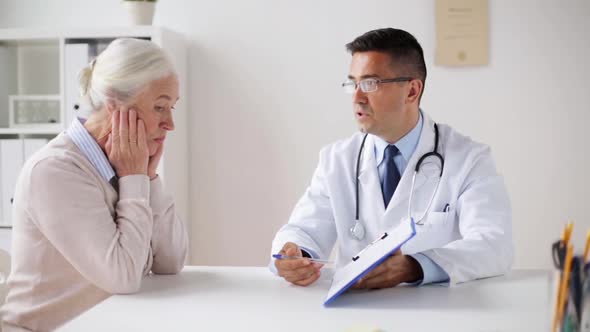 Senior Woman and Doctor with Cardiogram at Clinic alt
