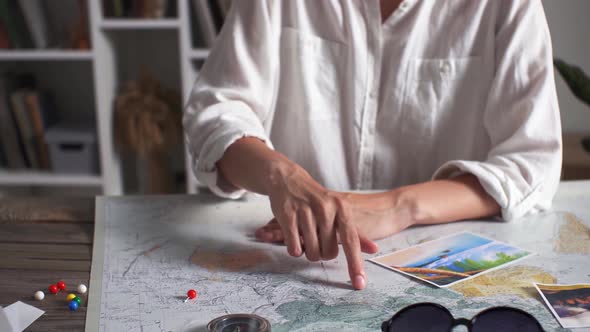 A Young Girl Is Planning A Honeymoon Vacation Trip With A Map. Map View. The Index Finger Shows alt