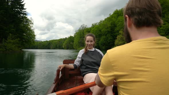 Couple Riding in a Rowing Boat on the Lake