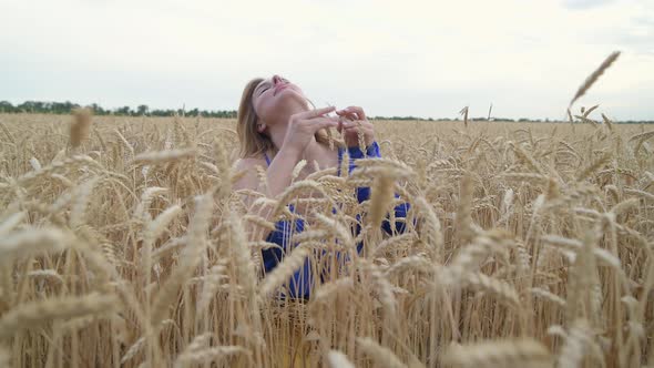 Beautiful Ukrainian Woman Wearing Dress in Ukrainian National Flag Colours Blue and Yellow at Wheat alt