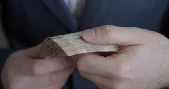 Male Hands Counting Money. Russian Money Banknotes of 5,000 Rubles