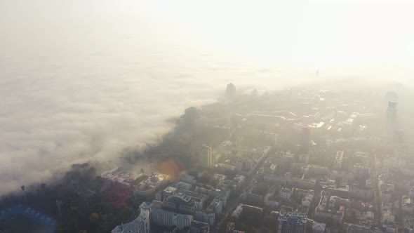Metropolis in Foggy Weather. The Big City Is Covered in Fog at Dawn. Fog in Kiev, Ukraine alt