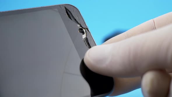 Technician Looking for Broken Screen on Smartphone