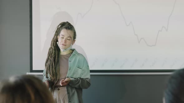 Businesswoman with Dreadlocks Delivering Financial Presentation alt