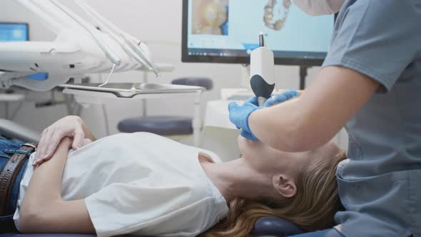 Orthodontist Using 3D Intraoral Scanner for Scanning Teeth Patient's alt