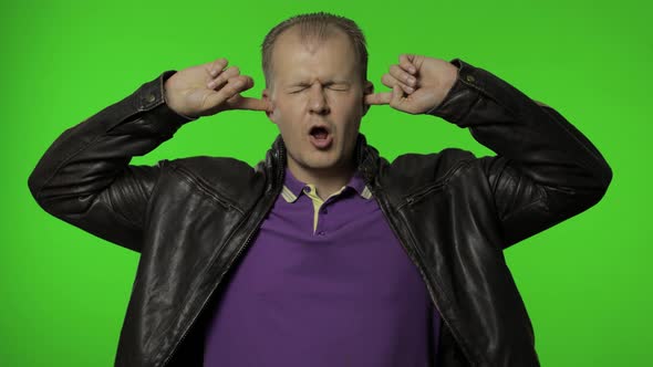 Don't Want Listen. Rocker Man Covering Ears with Arms Not To Hear Annoying Talk, Ignoring Conflict alt