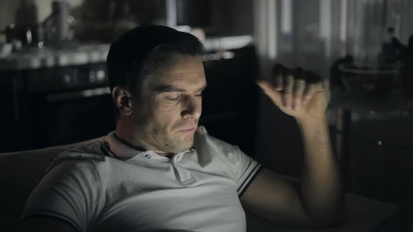 Exhausted Businessman Switching Off Notebook at Remote Workplace alt