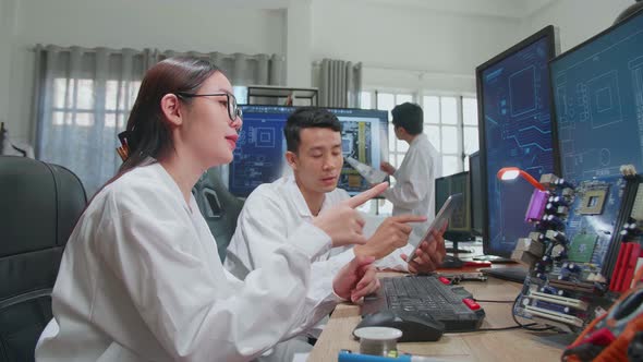 Asian Team Of Multi Engineers, Scientists Work On Tablet And Computer, Talk, Design Pcb alt