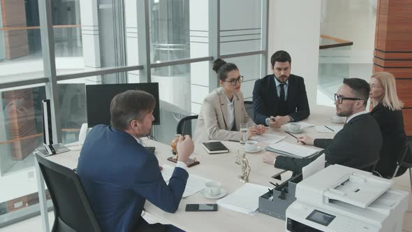 Team of Counsels Discussing Case at Meeting Table alt