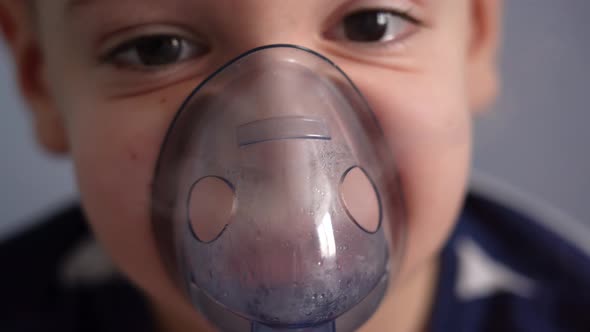 Close-up child breathing with a nebulizer