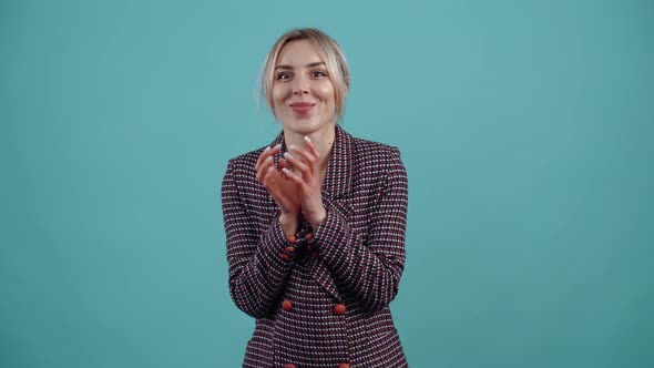 The Evil Blonde Clasping Her Hands Together Playing Conspiratorially with Her Fingers Devises a Plan alt