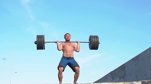 Professional Sportsman Preparing for Training with a Barbell. Slow Motion