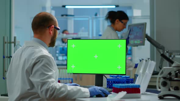 Researcher Looking at Chroma Key Display in Modern Equipped Lab alt