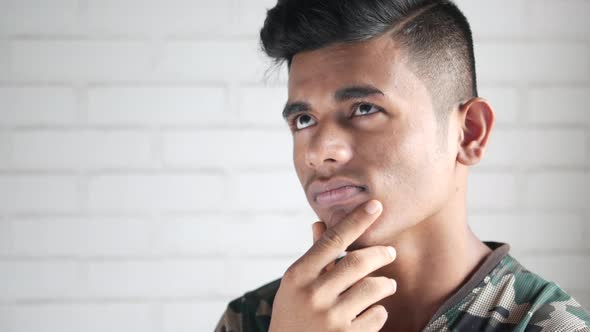 Thoughtful Young Man Hand Over Head Looking Away alt