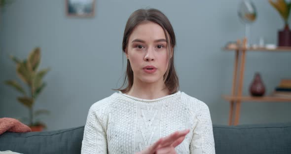 Close Up View of Woman Showing with Deaf-mute Sign Language Stop Animal Abuse While Sitting on Sofa alt