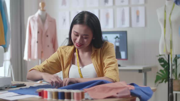 Asian Female Designer Creates A Template Of The Future Dress. She Draws A Chalk Outline alt