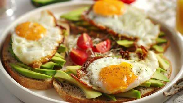 Close Up of Healthy Breakfast with Sliced Avocado Sandwiches with Fried Egg alt
