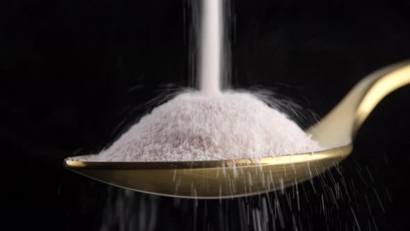 pouring collagen powder in golden spoon alt