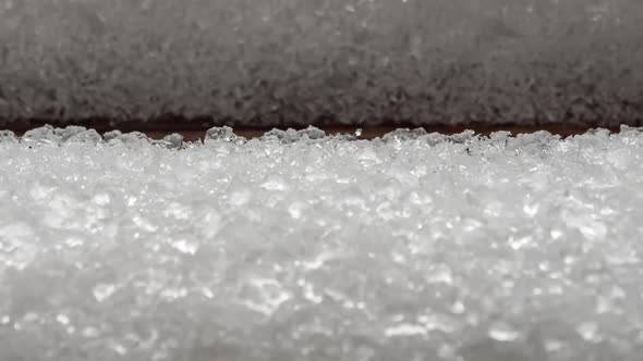 View of melting snow on wooden background. Soft focus.