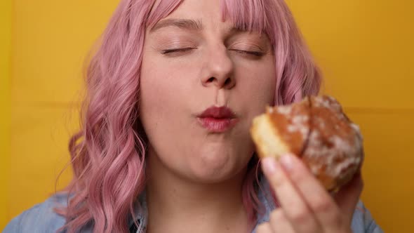 Charming Young Lovely Female Biting Sweet Doughnut Isolated Over Yellow Background alt