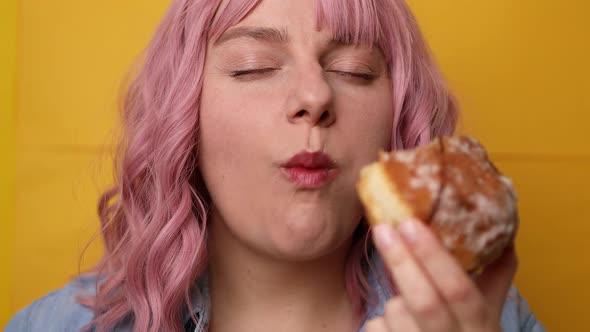 Charming Young Lovely Female Biting Sweet Doughnut Isolated Over Yellow Background
