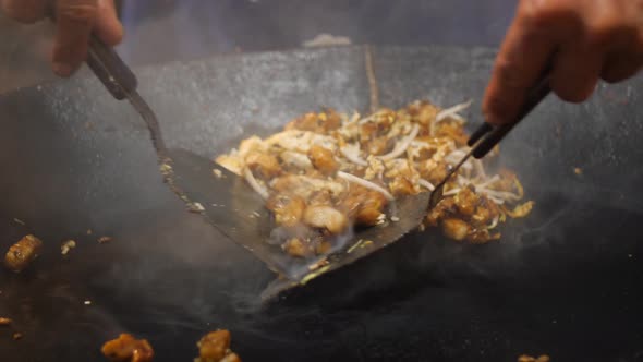 Asian Street Food: Chef Cooking Pad Thai in Wok at Night Food Market
