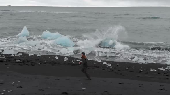 Slow Motion Aerial Shot Along Black Sand Beach. alt
