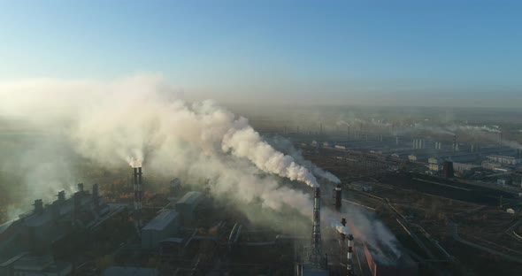 Aerial Veiw Of High Smokestack With Smoke Emission. Plant Pipes Pollute Atmosphere  alt