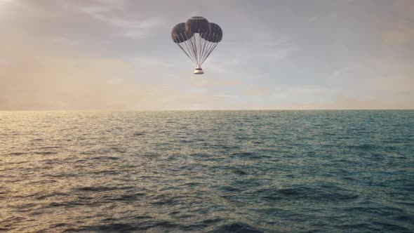 Space Capsule Returning to Earth with Parachutes over the Ocean