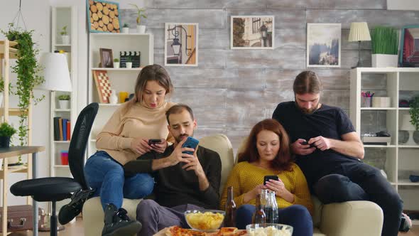 Group of Friends Sitting on Couch in Living Room alt