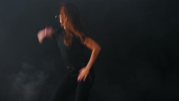 Young Attractive Woman Dancing in Dark Studio alt