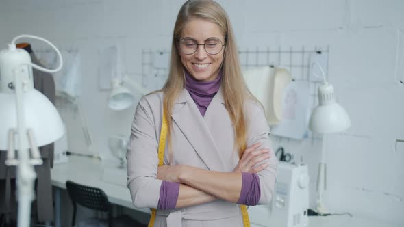 Slow Motion Portrait of Professional Fashion Designer Standing in Workshop Smiling Looking at Camera alt