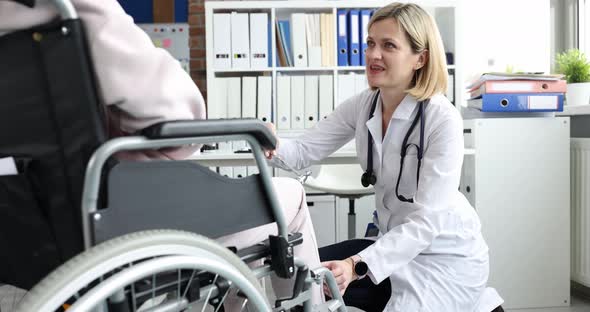 Doctor Uses Hammer Blow on Knee of Patient in Wheelchair alt