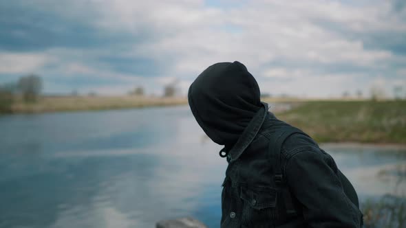 Man Sitting on the Pier Near the River