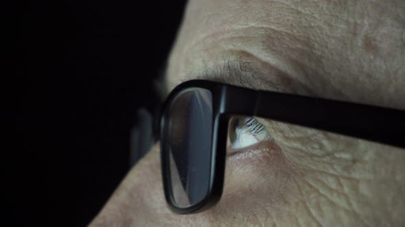 Man with Glasses Looks at the Screen alt