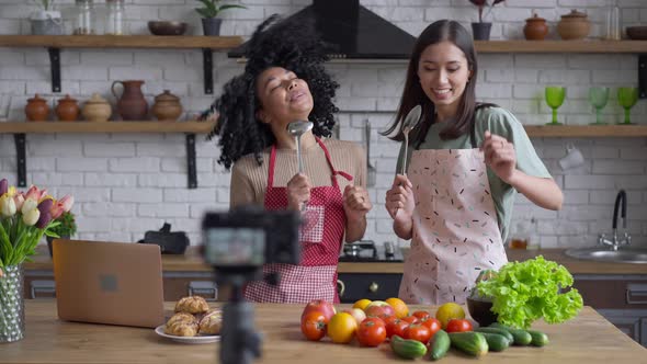 Joyful Slim Young Women Having Fun in Kitchen Recording Healthy Food Blog alt